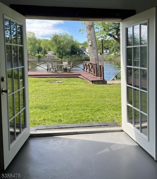 1 Lenape Ln, Harmony Twp, NJ 08865 - doorway to outside with a water view, finished concrete floors, and healthy amount of natural light