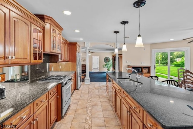 kitchen featuring a sink, appliances with stainless steel finishes, a ceiling fan, ornate columns, and recessed lighting