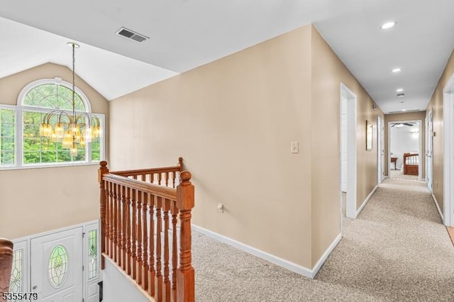 corridor featuring an upstairs landing, carpet, vaulted ceiling, recessed lighting, and a chandelier