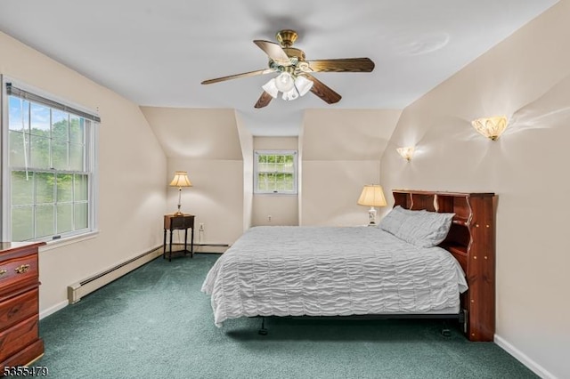 carpeted bedroom featuring multiple windows, vaulted ceiling, a baseboard heating unit, baseboards, and a ceiling fan