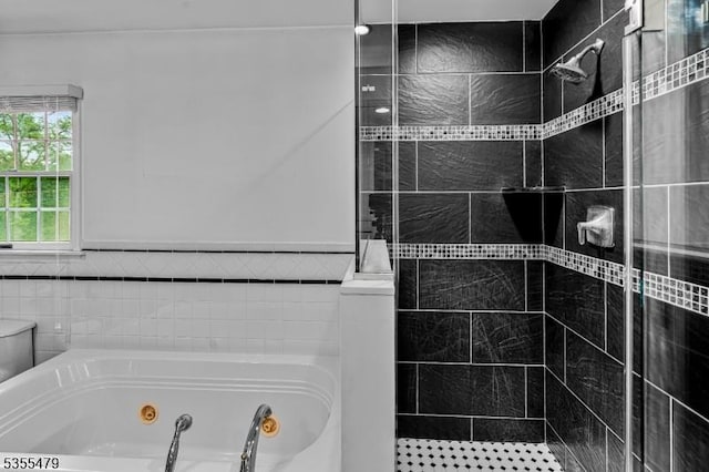 full bath with a shower stall, a tub with jets, and tile walls