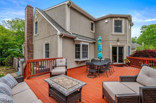 deck with outdoor dining area and outdoor lounge area