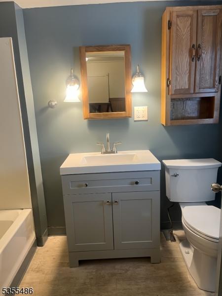 105 Chambers St, Phillipsburg Town, NJ 08865 - bathroom with toilet, vanity, baseboards, and a tub to relax in