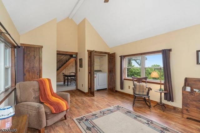 living area featuring washer / clothes dryer, high vaulted ceiling, beam ceiling, stairs, and wood finished floors