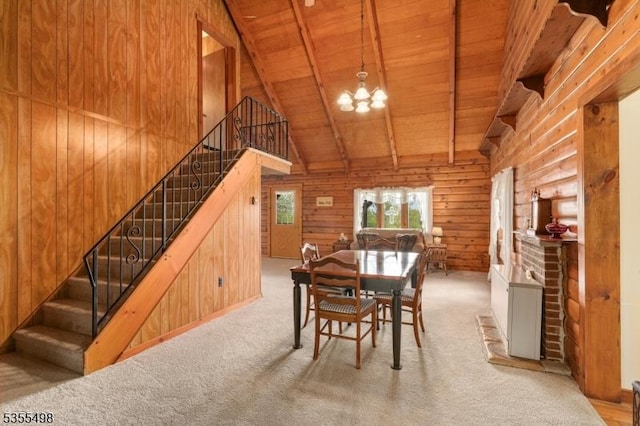 dining area featuring wooden ceiling, a chandelier, wood walls, high vaulted ceiling, and stairs