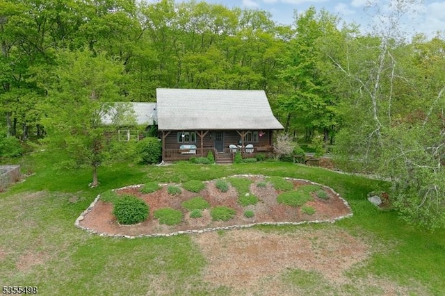 aerial view of property and surrounding area with a forest