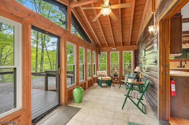 unfurnished sunroom with a sink, ceiling fan, and lofted ceiling