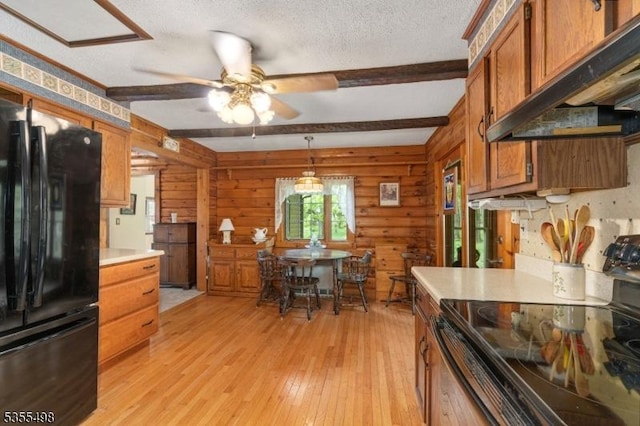kitchen with freestanding refrigerator, electric stove, under cabinet range hood, a ceiling fan, and light wood-style flooring
