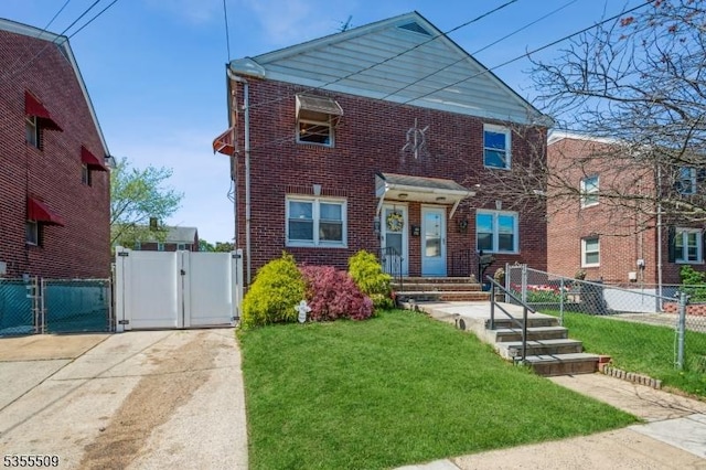 view of front of property featuring brick siding, fence, a gate, and a front lawn