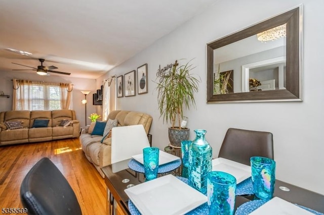 living room featuring a ceiling fan and wood finished floors