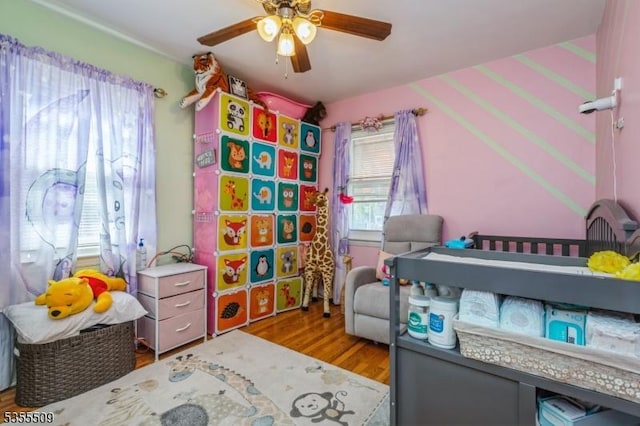 bedroom with ceiling fan and wood finished floors