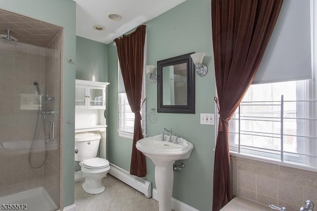 full bath featuring a baseboard heating unit, a shower stall, toilet, tile patterned floors, and baseboards