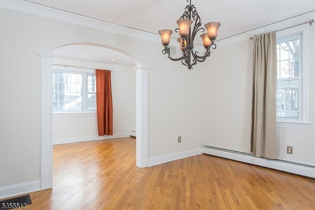 spare room featuring arched walkways, baseboard heating, crown molding, a chandelier, and light wood-style flooring