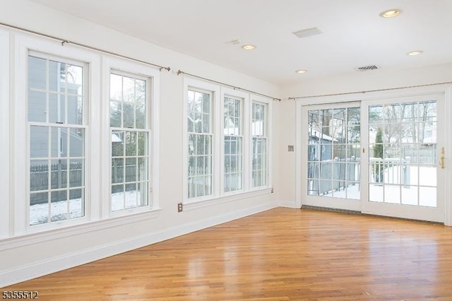 doorway with baseboards, light wood-style flooring, and recessed lighting