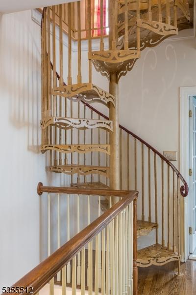staircase with wood finished floors