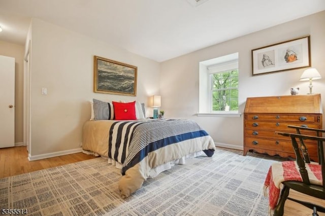bedroom featuring baseboards and wood finished floors