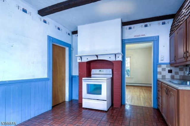 kitchen with electric range, brick patterned floor, baseboard heating, a sink, and backsplash