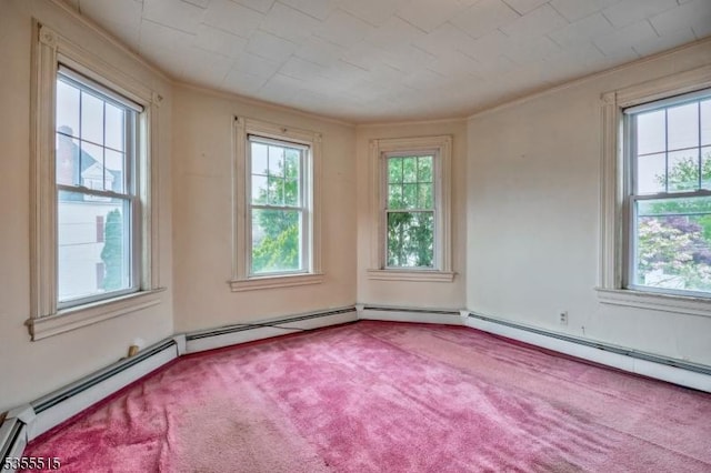 empty room with carpet flooring, ornamental molding, a wealth of natural light, and a baseboard radiator