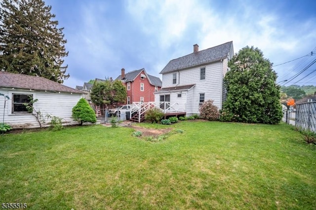 view of yard featuring fence and a wooden deck
