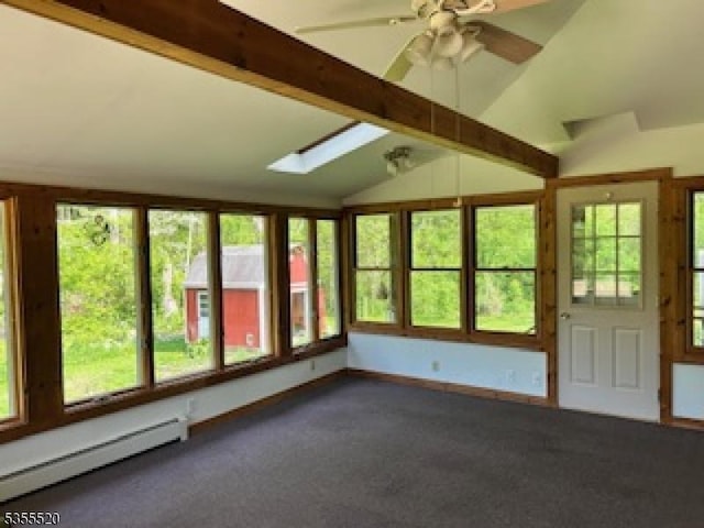 unfurnished sunroom featuring a baseboard heating unit, vaulted ceiling, a skylight, and carpet flooring