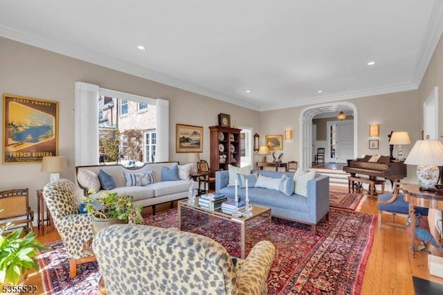 living room with crown molding, recessed lighting, and wood finished floors