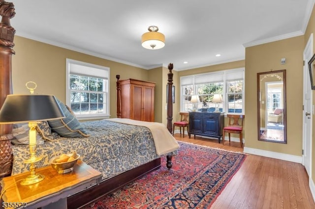 bedroom featuring crown molding, recessed lighting, baseboards, and hardwood / wood-style flooring