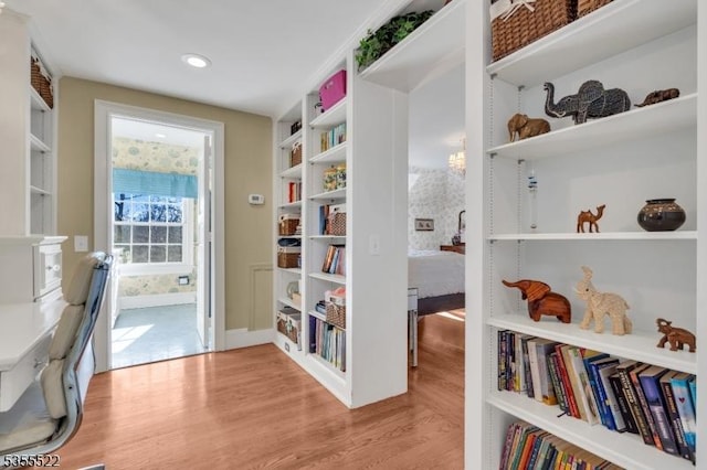 interior space featuring recessed lighting, baseboards, built in features, and wood finished floors