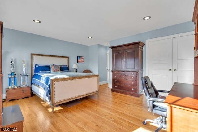 bedroom with recessed lighting, a closet, and light wood finished floors