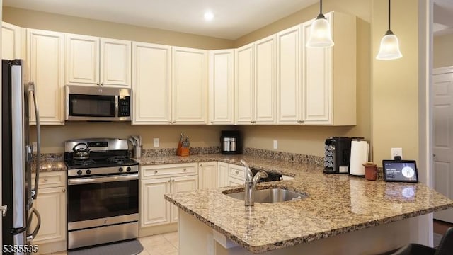 7104 Minuteman Ln, Franklin Twp, NJ 08873 - kitchen with stainless steel appliances, a sink, a peninsula, light stone countertops, and pendant lighting