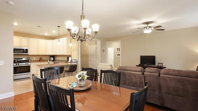 7104 Minuteman Ln, Franklin Twp, NJ 08873 - dining space featuring a chandelier, a ceiling fan, recessed lighting, light wood-type flooring, and baseboards