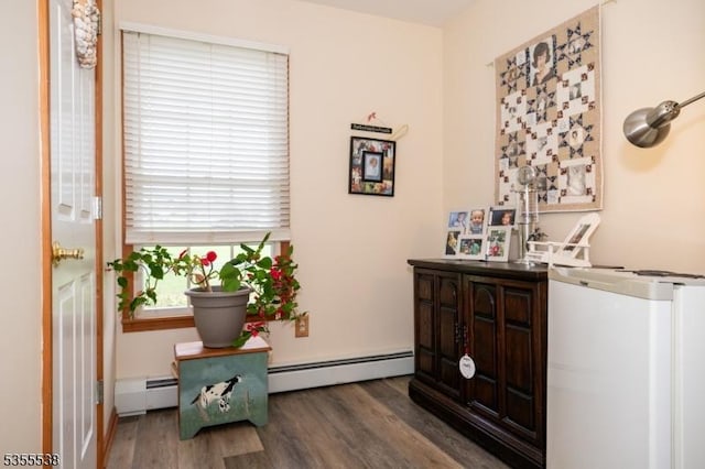 interior space with a baseboard radiator and wood finished floors