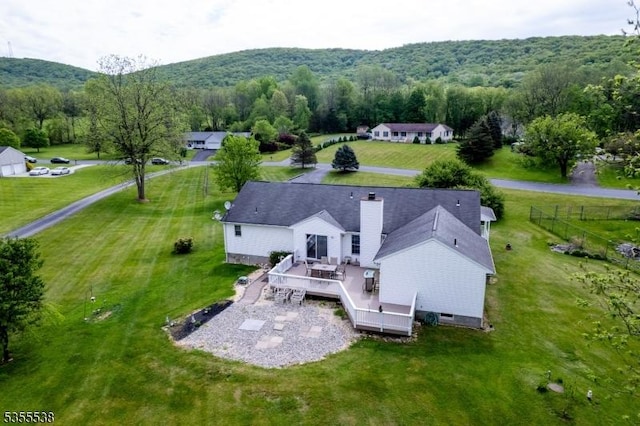 aerial view of property and surrounding area featuring a heavily wooded area