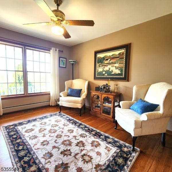 202 Fredon Springdale Rd, Fredon Twp, NJ 07860 - sitting room with wood finished floors, a baseboard radiator, and ceiling fan