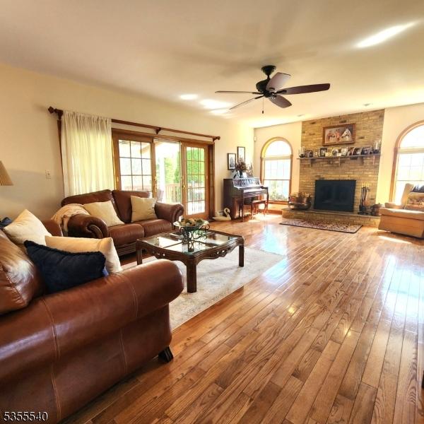 202 Fredon Springdale Rd, Fredon Twp, NJ 07860 - living area with hardwood / wood-style floors, ceiling fan, and a brick fireplace