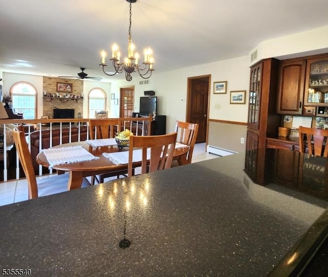 202 Fredon Springdale Rd, Fredon Twp, NJ 07860 - dining area with a baseboard radiator, a brick fireplace, ceiling fan with notable chandelier, and visible vents