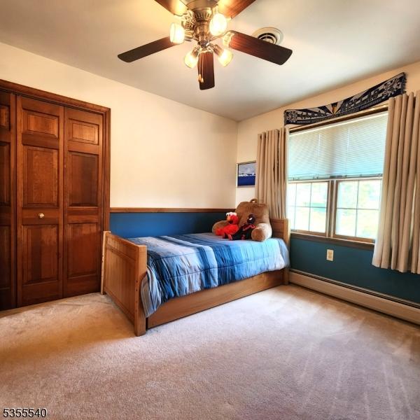 202 Fredon Springdale Rd, Fredon Twp, NJ 07860 - bedroom featuring a baseboard heating unit, visible vents, ceiling fan, and light colored carpet