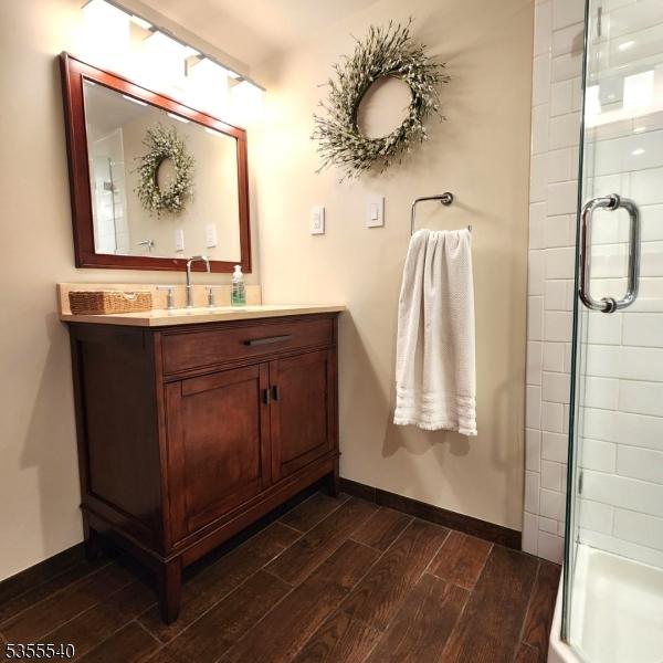 202 Fredon Springdale Rd, Fredon Twp, NJ 07860 - full bathroom featuring a shower stall, baseboards, vanity, and wood finished floors
