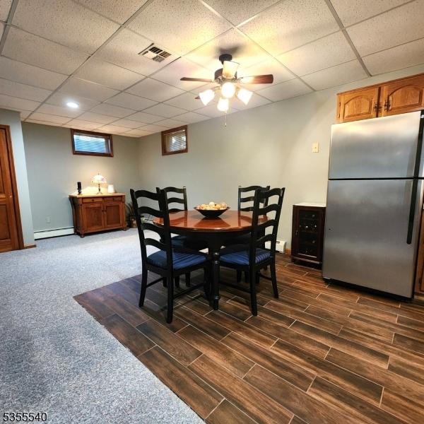 202 Fredon Springdale Rd, Fredon Twp, NJ 07860 - dining area featuring a paneled ceiling, baseboard heating, and dark wood finished floors