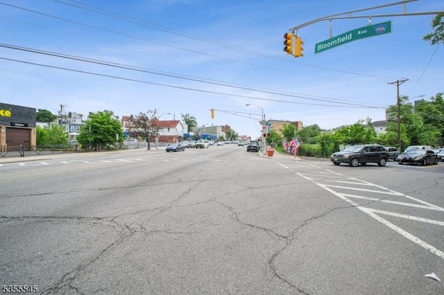 126 Highland Ave, Newark City, NJ 07104 - view of asphalt road featuring traffic lights, sidewalks, street lights, curbs, and traffic signs