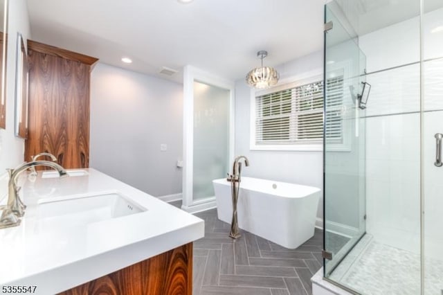 9 Warwick Rd, Chatham Twp, NJ 07928 - bathroom featuring a stall shower, a soaking tub, double vanity, recessed lighting, and baseboards