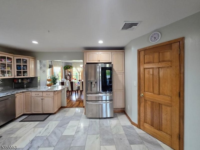 133 River Rd, Montague Twp, NJ 07827 - kitchen with stainless steel appliances, glass insert cabinets, light stone counters, recessed lighting, and light brown cabinets