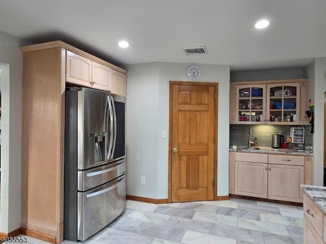 133 River Rd, Montague Twp, NJ 07827 - kitchen with stainless steel refrigerator with ice dispenser, light stone countertops, glass insert cabinets, tasteful backsplash, and light brown cabinetry