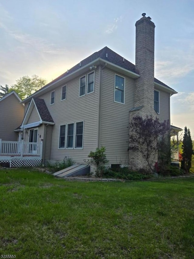 133 River Rd, Montague Twp, NJ 07827 - back of property with a chimney, a deck, and a yard