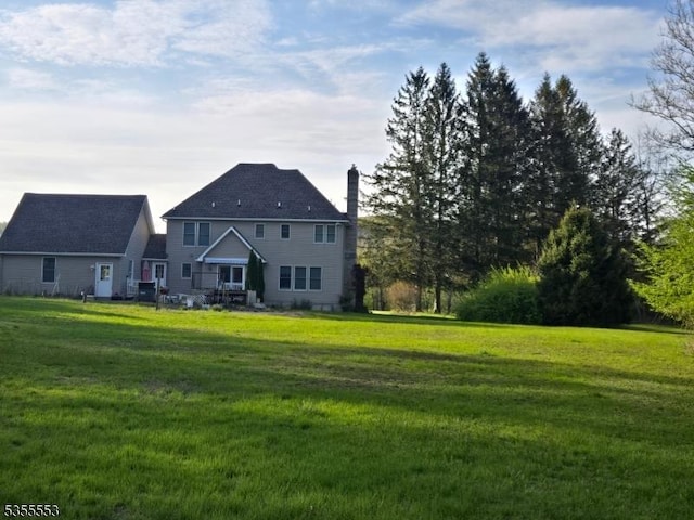 133 River Rd, Montague Twp, NJ 07827 - rear view of property featuring a chimney and a yard