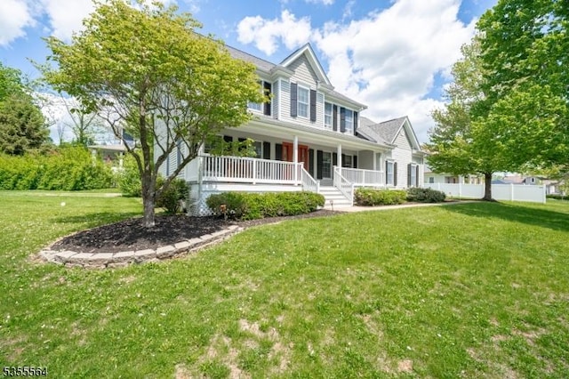 colonial home with covered porch and a front yard