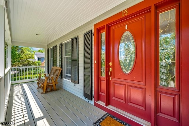 view of exterior entry featuring covered porch