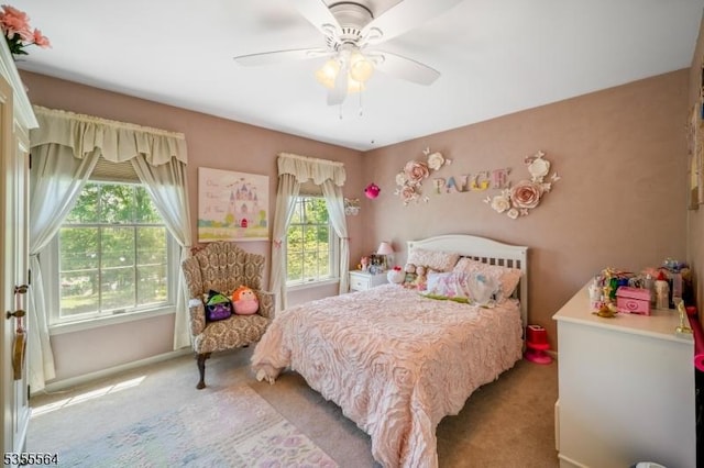 bedroom featuring light colored carpet and ceiling fan