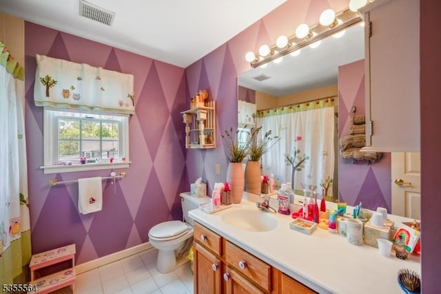bathroom featuring toilet, vanity, tile patterned floors, and a shower with curtain