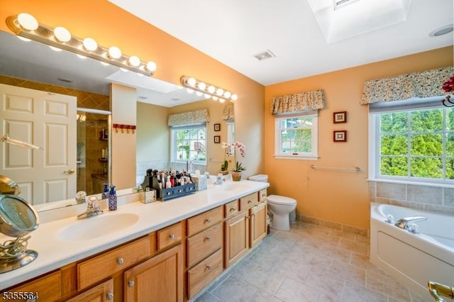 full bath featuring plenty of natural light, a stall shower, double vanity, and toilet
