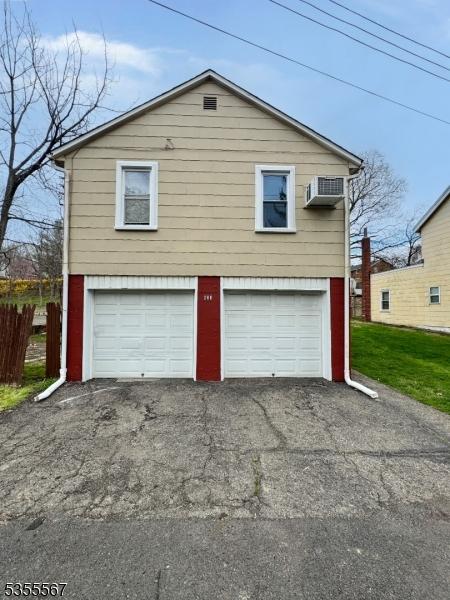 633 Warren St, Phillipsburg Town, NJ 08865 - garage with driveway and an AC wall unit